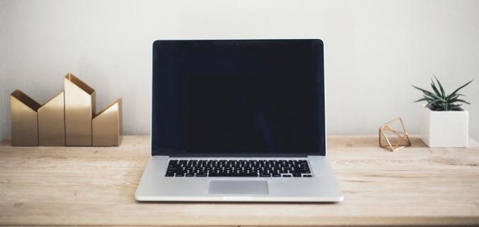 MacBook Pro on top of brown table