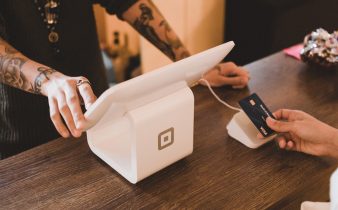 person holding white POS machine