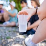 a person holding a plastic cup