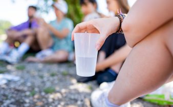 a person holding a plastic cup